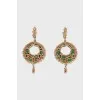 Gold earrings decorated with emeralds
