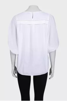 A loose blouse decorated with rhinestones