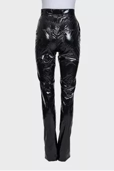 Black patent leather trousers with tag