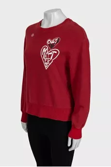 Red straight-cut sweatshirt with a print