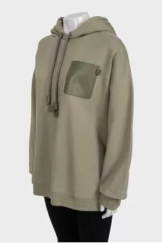 Green hoodie with a patch pocket
