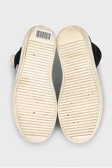 Black high-top sneakers with a zipper and laces