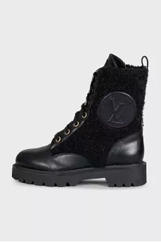 Black leather boots with a gold logo