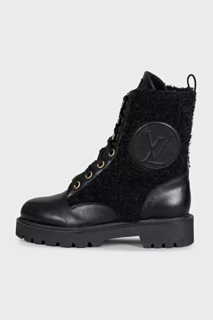 Black leather boots with a gold logo