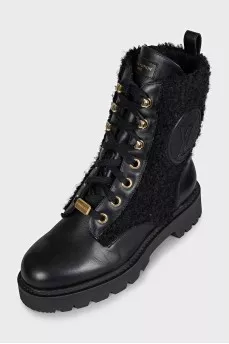 Black leather boots with a gold logo