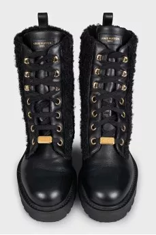 Black leather boots with a gold logo