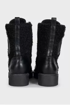 Black leather boots with a gold logo