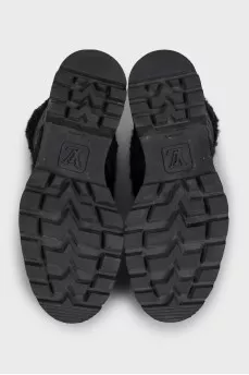 Black leather boots with a gold logo