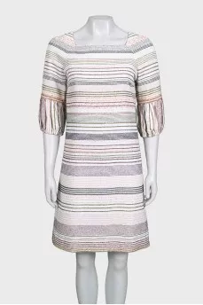 A straight-cut dress decorated with chains