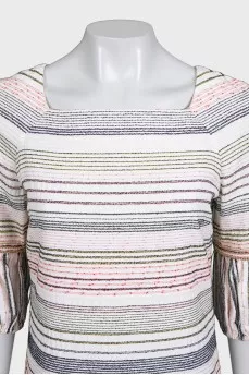 A straight-cut dress decorated with chains