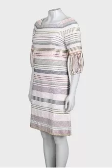 A straight-cut dress decorated with chains