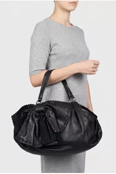 Black leather bag with a bow