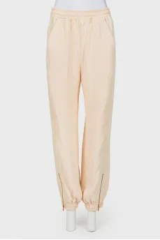 Beige pants with zips at the bottom