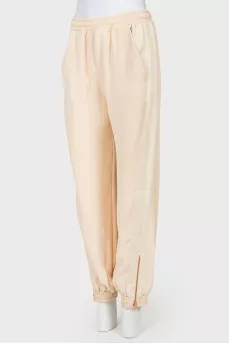 Beige pants with zips at the bottom