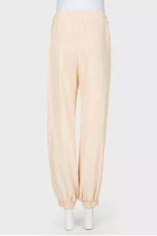 Beige pants with zips at the bottom