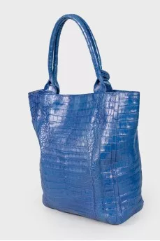 Blue bag with feather accessory