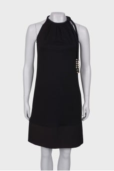 Black dress with ties and pearls