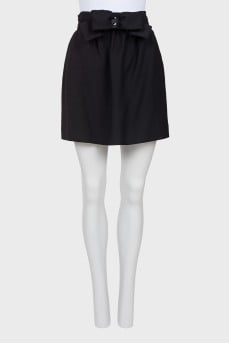 Skirt is decorated with a bow