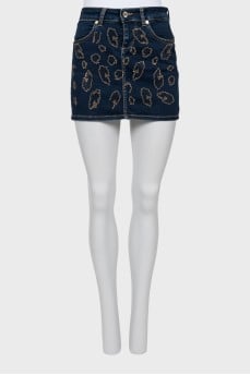 Denim miniskirt decorated with rhinestones