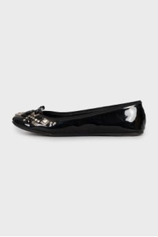 Leather ballet shoes decorated with rhinestones and a bow