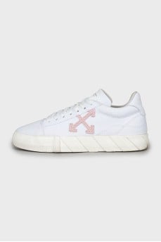 White sneakers decorated with a tag