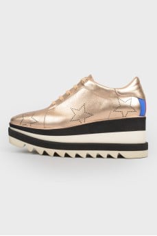 Golden shoes on the platform