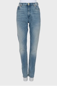 Jeans decorated with embroidered patches