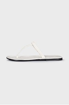 White leather flip flops with tag