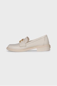 Beige loafers with metal logo