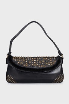 Leather bag decorated with rivets and fur
