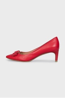 Red leather shoes decorated with a bow