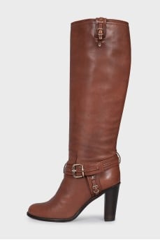 Brown boots decorated with a strap