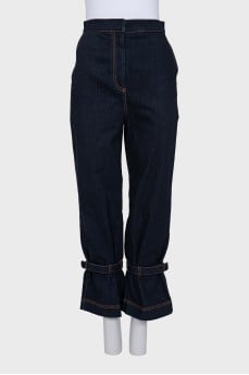 Dark blue jeans decorated with straps
