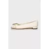 White ballerinas with golden logo