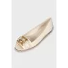 White ballerinas with golden logo