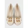 White ballerinas with golden logo