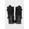 Leather boots decorated with straps