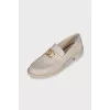 Beige loafers with metal logo