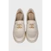 Beige loafers with metal logo