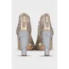 Golden shoes with figured heels