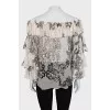 Sheer blouse with printed pleats
