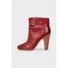 Red leather ankle boots with perforation