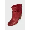 Red leather ankle boots with perforation