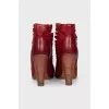 Red leather ankle boots with perforation
