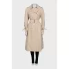 Beige trench coat with plaid lining