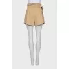 Beige shorts with a belt