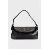 Leather bag decorated with rivets and fur