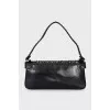 Leather bag decorated with rivets and fur