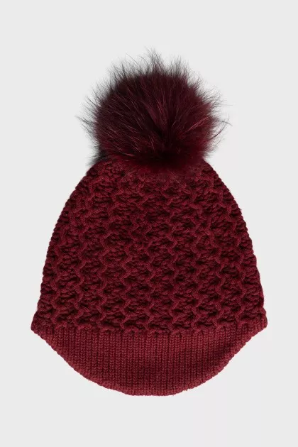 Red knitted hat with a pompom