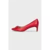 Red leather shoes decorated with a bow
